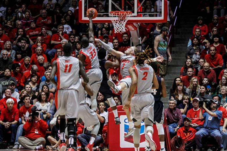 Deshawn Delaney #33 assisted by Hugh Greenwood #3 of the New Mexico Lobos blocks a shot attempted by Darius Perkins (C) of the Utah State Aggies during their game at The WisePies Arena on February 7, 2015 in Albuquerque, New Mexico. Utah State won 63-60. (Getty)