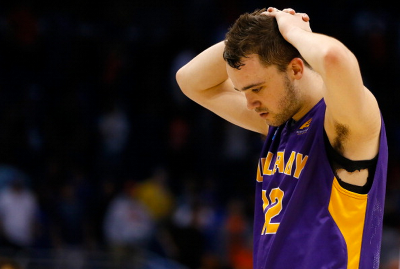 Peter Hooley #12 of the Albany Great Danes walks off the court after losing to the Florida Gators 67-55 during the second round of the 2014 NCAA Men's Basketball Tournament at Amway Center on March 20, 2014 in Orlando, Florida. (Getty)