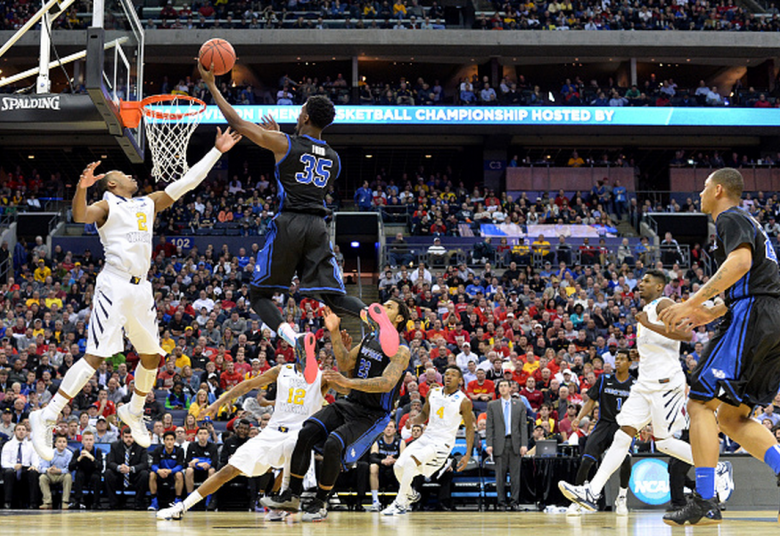 Xavier Ford #35 of the Buffalo Bulls shoots against Jevon Carter #2 of the West Virginia Mountaineers in the second half during the second round of the 2015 NCAA Men's Basketball Tournament at Nationwide Arena on March 20, 2015 in Columbus, Ohio. (Getty)