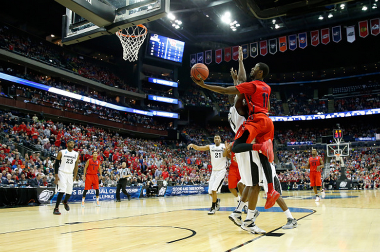 Dayton's Scoochie Smith puts up a shot in front of Providence's Ben Bentil in the 2015 NCAA Men's Basketball Tournament. (Getty)