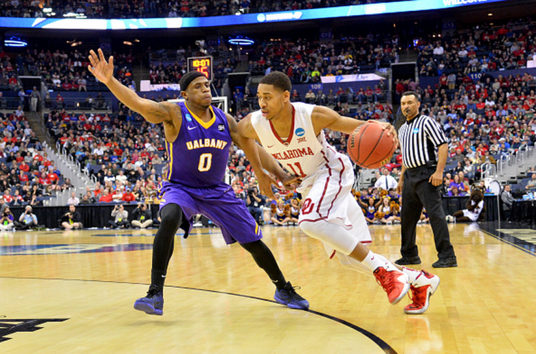 Oklahoma's Isaiah Cousins drives around Albany's Evan Singletary in the 2015 NCAA Men's Basketball Tournament. (Getty)