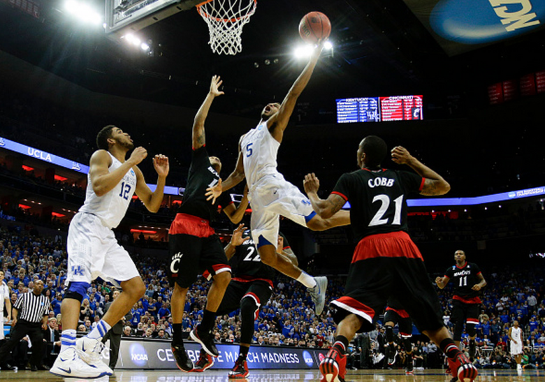 Kentucky's Andrew Harrison drives in for the basket and a foul as the Wildcats defeated Cincinnati, 64-51, in the third round of the NCAA Tournament. (Getty)