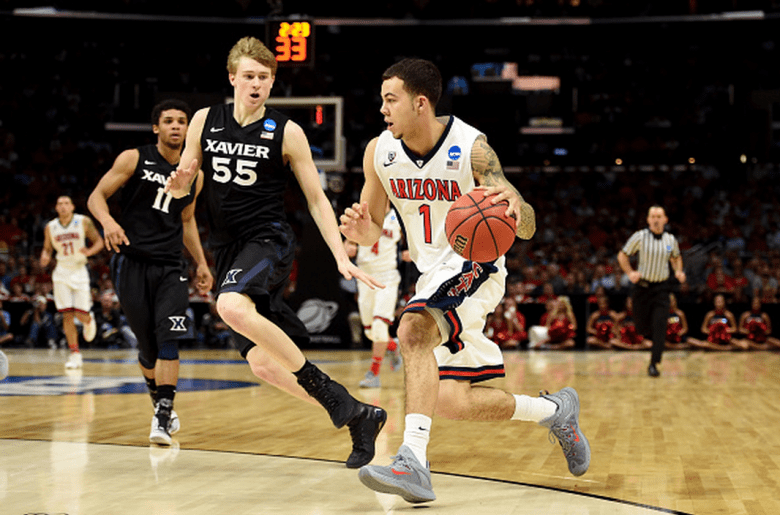 Arizona's Gabe York drives on Xavier's J.P. Macura in the 2015 NCAA Men's Basketball Tournament. (Getty)