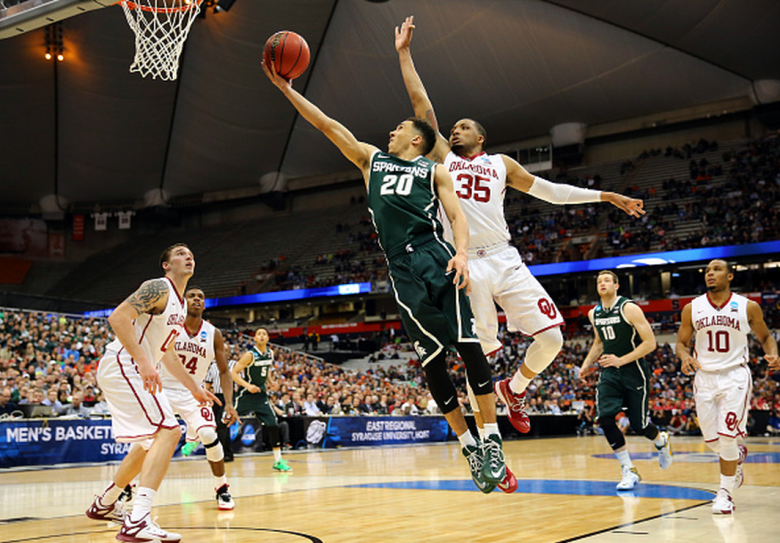 Michigan State's Travis Trice shoots the ball against Oklahoma's TaShawn Thomas during the 2015 NCAA Men's Basketball Tournament. (Getty)
