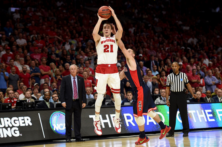 Wisconsin's Josh Gasser makes a three-pointer against Arizona's T.J. McConnell in the 2015 NCAA Men's Basketball Tournament. (Getty)