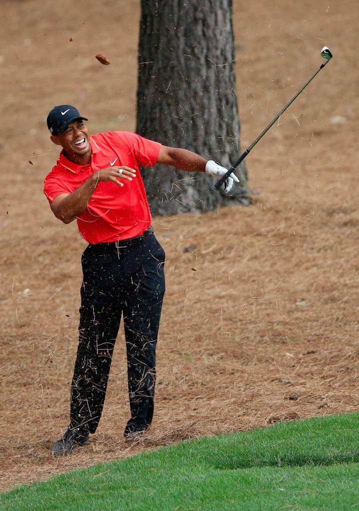 Tiger Woods said he felt a bone pop out in his right wrist after hitting a hidden tree root on a shot. (Getty)