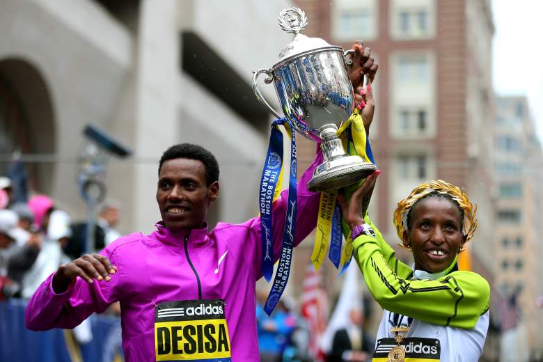 Lelisa Desisa (left) and Caroline Rotich celebrate their titles at the 119th Boston Marathon Monday. (Getty)