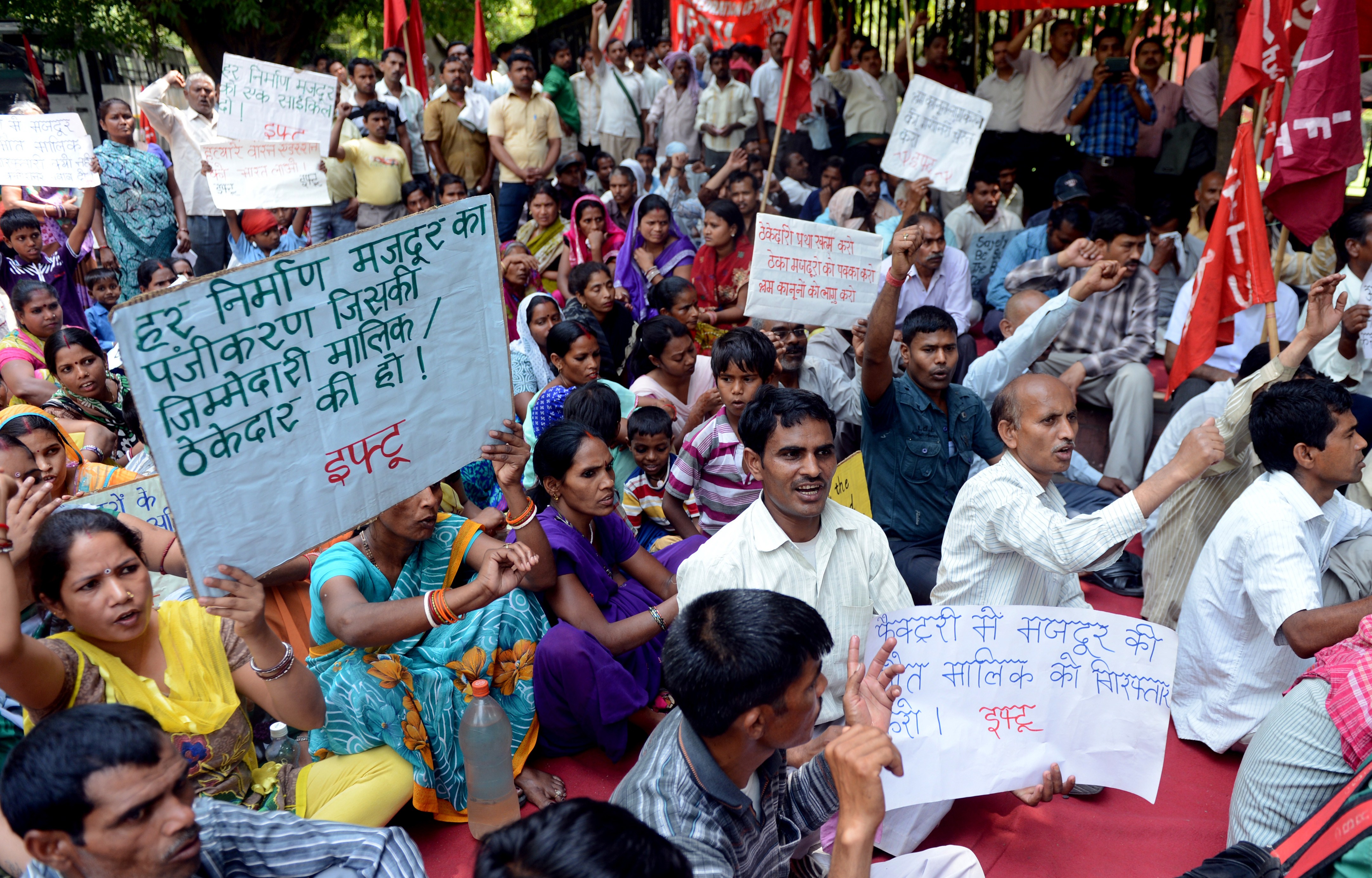 Activists from the Indian Federation of Trade Unions, Communist trade union workers and factory workers hold placards during a protest against state and central government policies that they say negatively impact workers on International Labour Day in New Delhi on May 1, 2014.  (Getty)