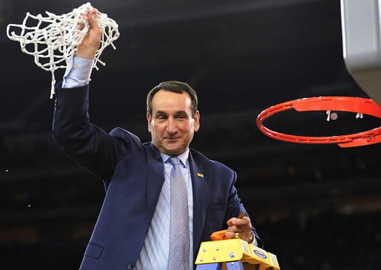 Duke's head coach Mike Krzyzewski waves to fans with the net after defeating Gonzaga in the Elite Eight of the 2015 NCAA Men's Basketball Tournament. (Getty)