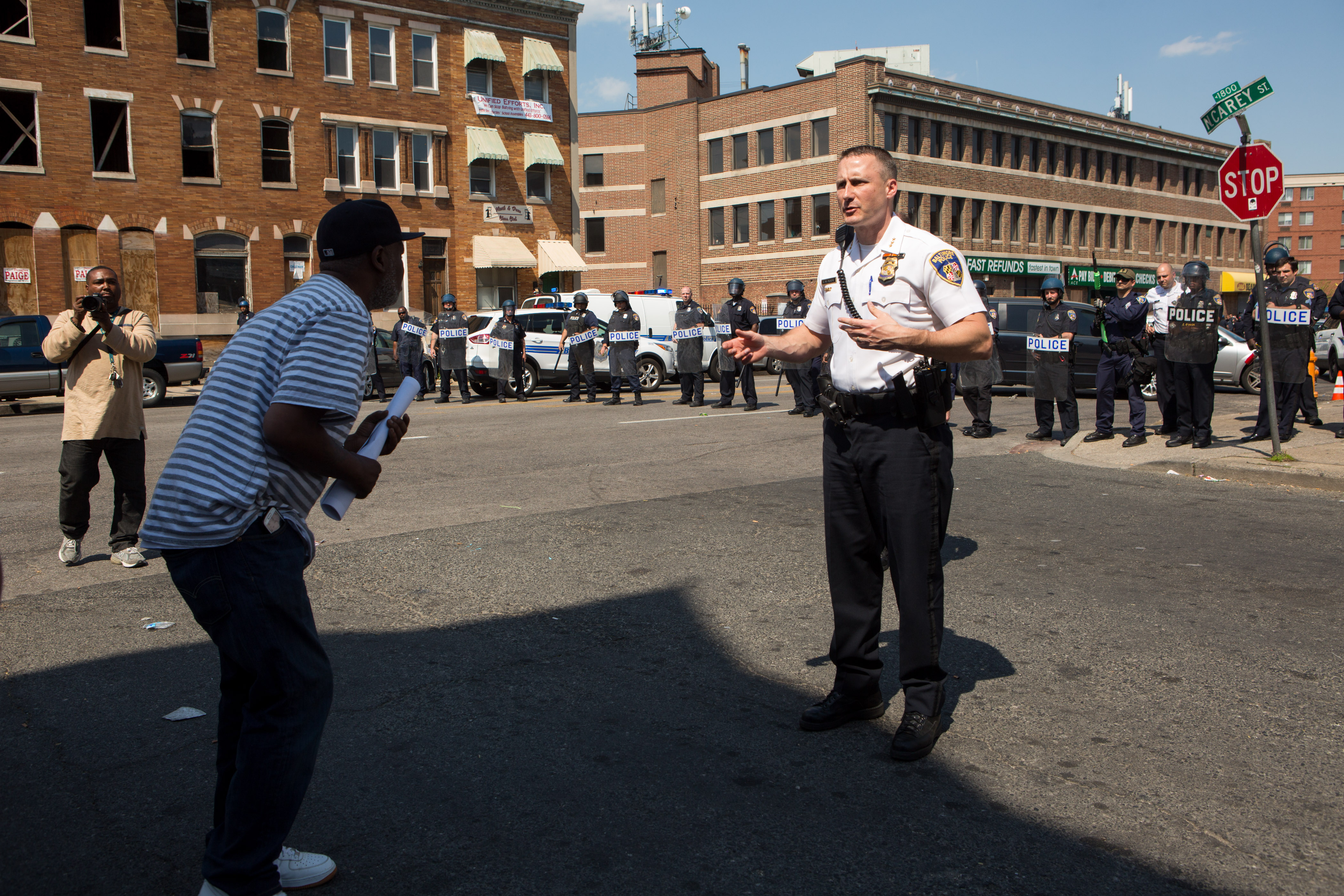 A man faces off with Baltimore Deputy Police Commissioner Dean Palmere on North Avenue. (Getty)