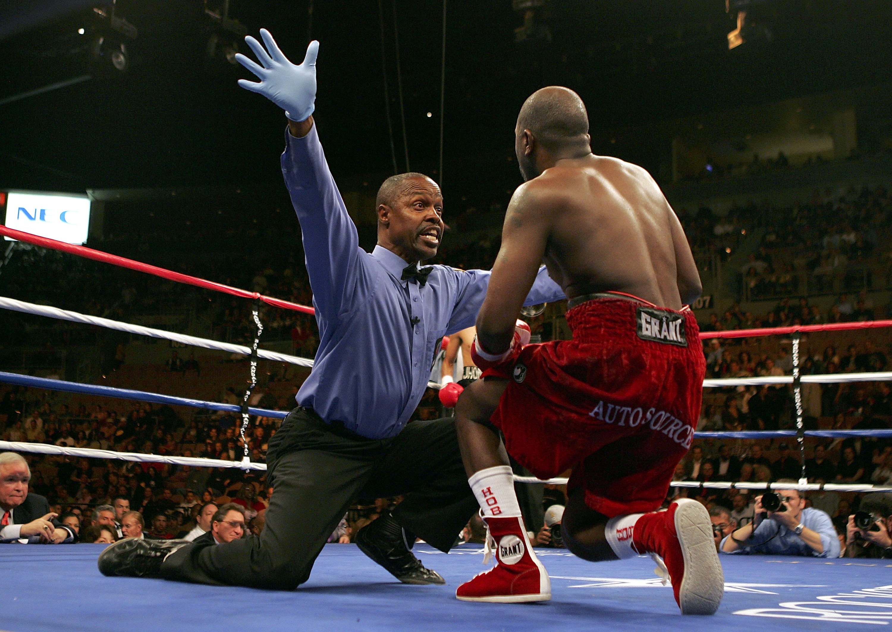 Kenny Blayless calls the fight in the 8th round as Marc Johnson attempts to stand. (Getty)