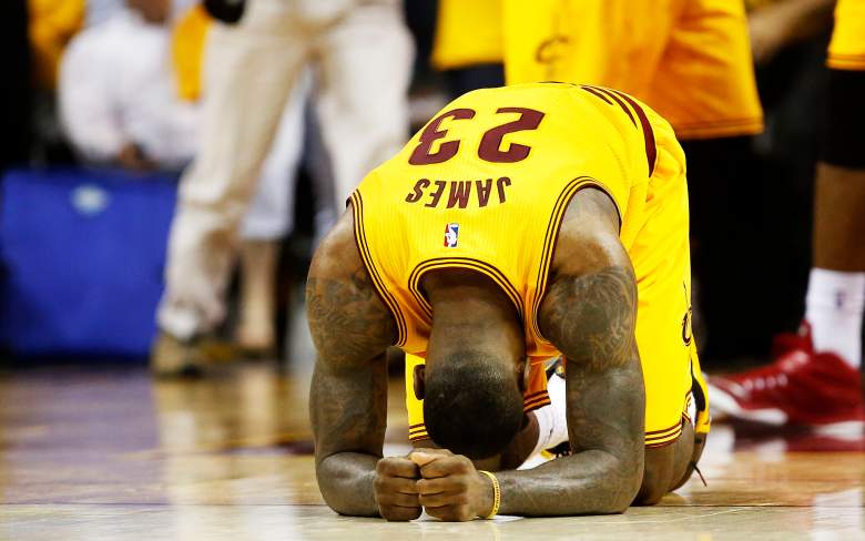 LeBron James crumbles to the floor after Cleveland's win over Atlanta in Game 3 on Sunday. (Getty)