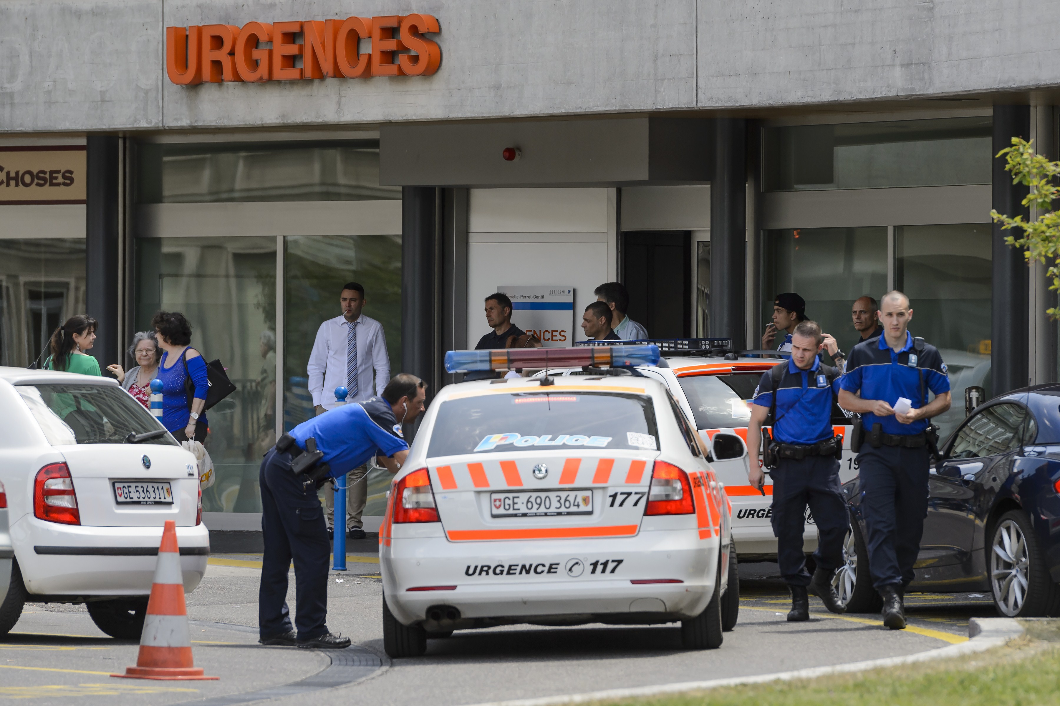 Police and security outside the Geneva hospital where Kerry was brought for care after the crash. (Getty)