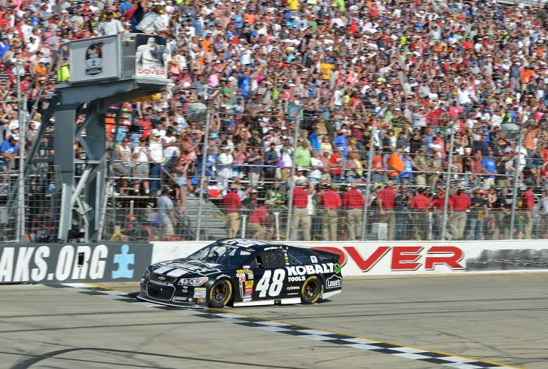 Jimmie Johnson takes the checkered flag in the 2014 FedEx 400 benefiting Autism Speaks. (Getty)