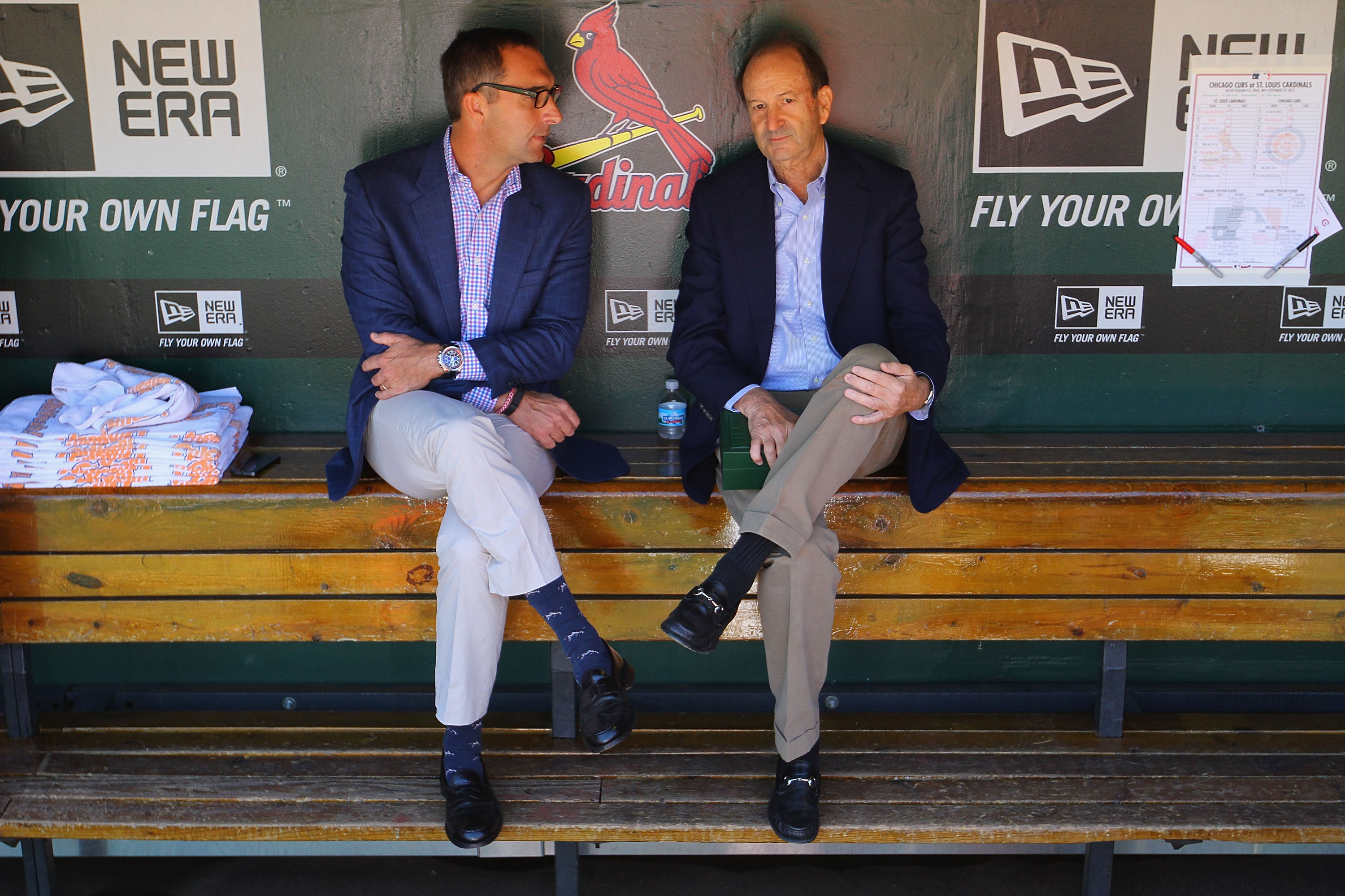 St. Louis Cardinals general manager John Mozeliak, left, and Bill DeWitt, Jr., the Cardinals managing partner and chairman, talk in the dugout prior to a game against the Chicago Cubs at Busch Stadium on September 29, 2013. (Getty)