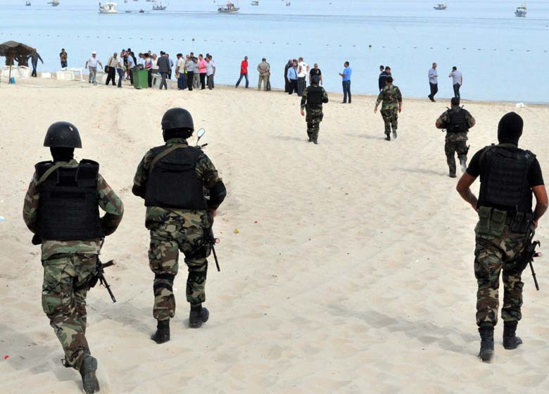 Tunisian security forces inspect a beach after a failed suicide bomb attack near the four-star Riadh Palms hotel, in  Sousse, 90 miles south of Tunis, on October 30, 2013.  Tunisian security forces arrested five Salafist "terrorists" with links to two failed attacks in coastal resort towns, the first suicide bids in the country for more than a decade. Today's failed suicide bombings are the first in Tunisia since 2002, when an attack claimed by Al-Qaeda killed 21 people at the ancient Ghriba synagogue on the resort island of Djerba. (Getty)