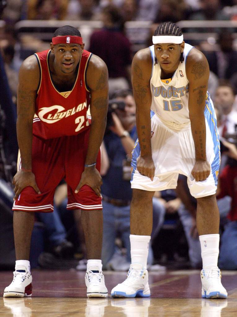 LeBron James, left, and Carmelo Anthony take a breather during a game in their rookie seasons. James was the No. 1 pick in 2003, Anthony 3rd. (Getty)