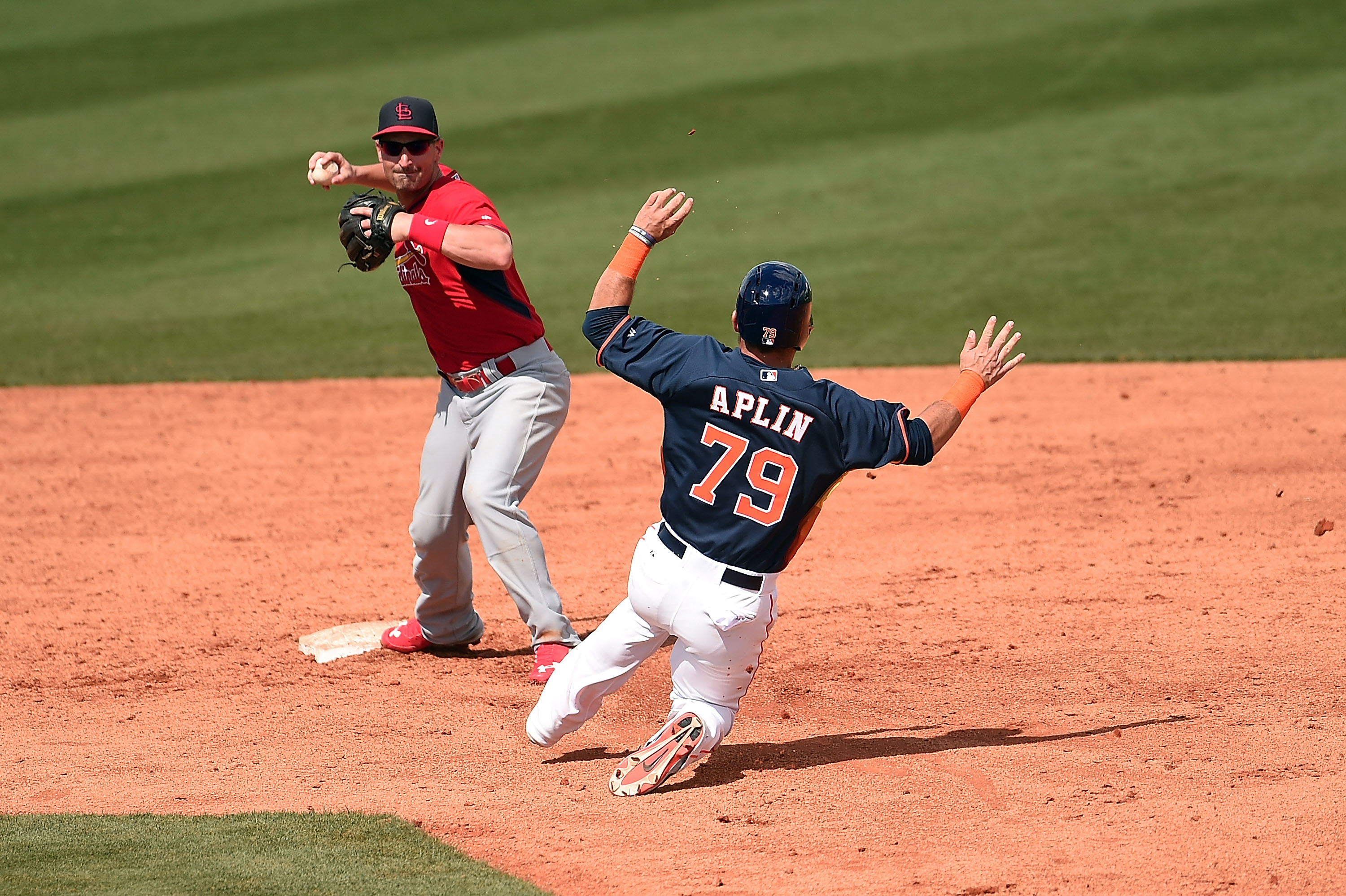Andrew Aplin, of the Houston Atros, slides into second base as Dean Anna, of the St. Louis Cardinals, turns a double play during a 2015 Spring Training game. (Getty)