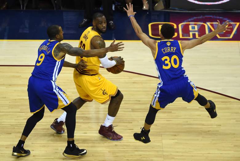 Golden State's Andre Iguodala, left, and Steph Curry apply the pressure on LeBron James in Game 4. (Getty)