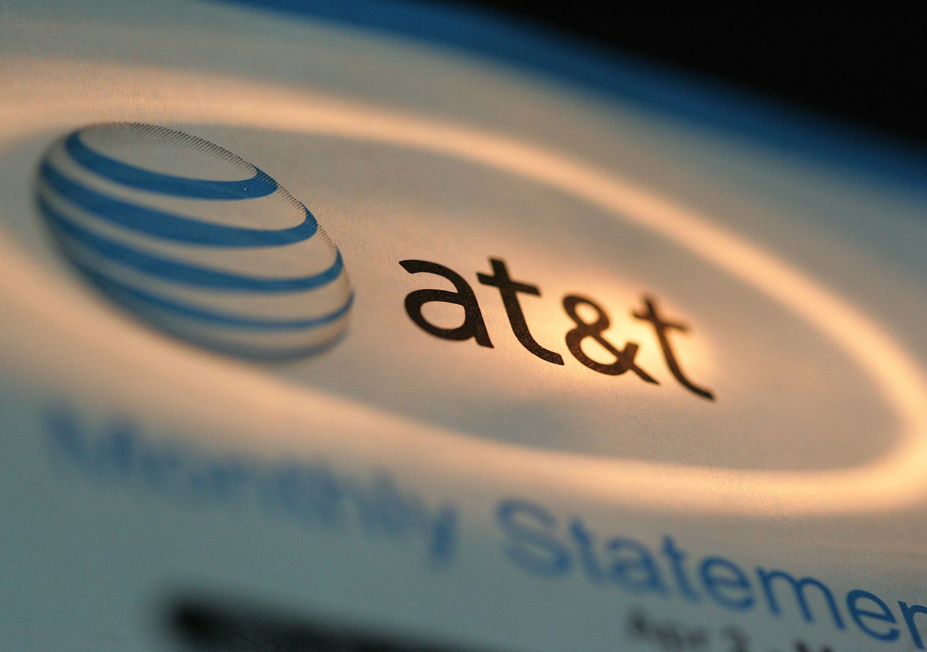 The AT&T logo is seen atop a phone bill. (Getty)