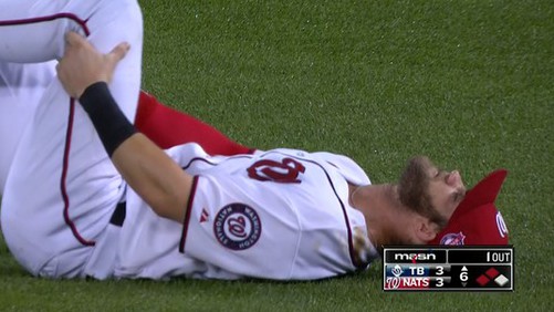Washington Nationals star Bryce Harper lays on the ground in pain after suffering an apparent knee injury Thursday vs. the Tampa Bay Rays (Twitter/masnNationals)