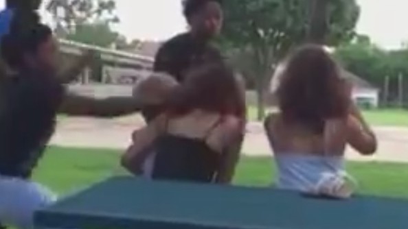 The 13-year-old Texas girl grabbed the 14-year-old by the hair, throwing her to the ground and causing the 3-year-old boy to fall from her arms. (LiveLeak)