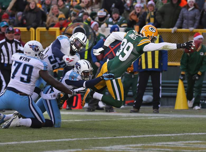 GREEN BAY, WI - DECEMBER 23: James Jones #89 of the Green Bay Packers reaches over the goal line to score as he is hit by Jarius Wynn #79, Zach Brown #55 and Alterraun Verner #20 of the Tennessee Titans at Lambeau Field on December 23, 2012 in Green Bay, Wisconsin. The Packers defeated the Titans 55-7. (Photo by Jonathan Daniel/Getty Images)