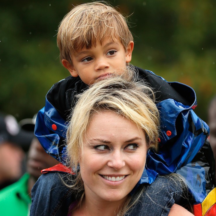 Tiger Woods' son, Charlie Woods, sits on ex-girlfriend Lindsey Vonn's shoulder while he watches his father play at the Tour Championship. (Getty)