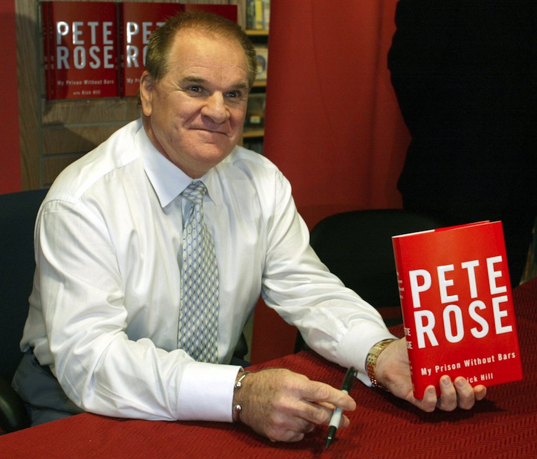 Pete Rose holds up a copy of his new book titled "Pete Rose My Prison Without Bars" after confessing this week that he bet on baseball games in 1987 and 1988. (Timothy A. Clary/AFP/Getty)