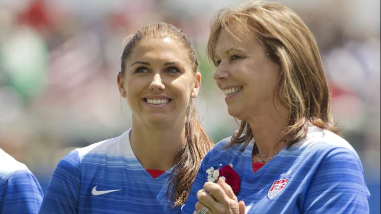 USWNT star Alex Morgan (L) with her mom, Pam, during player introductions before a Mother's Day match against Ireland in 2015. (Getty)