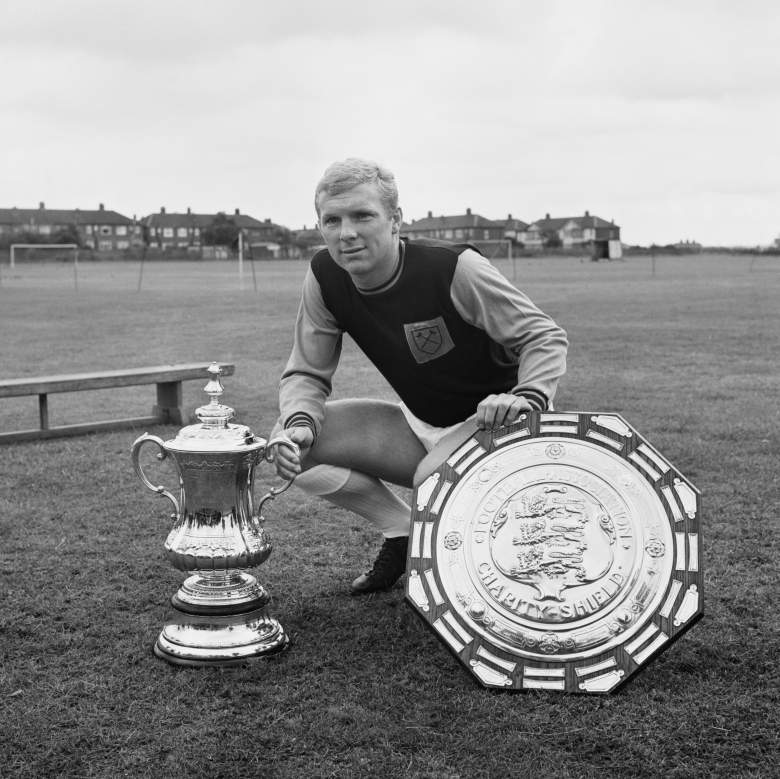 West Ham legend Bobby Moore  with the FA Cup (L) and the Charity Shield in 1964. (Getty)