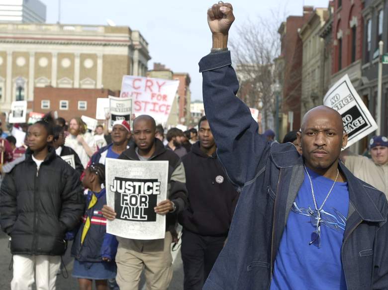 Protester Bzone Lewis and hundreds of others participate in a March for Justice April 7, 2002 in Cincinnati, OH. The march was held to mark the one year anniversary police shooting death of Timothy Thomas, an unarmed 19-year-old African-American youth. The shooting death sparked race riots in the area one year ago. (Getty Images)