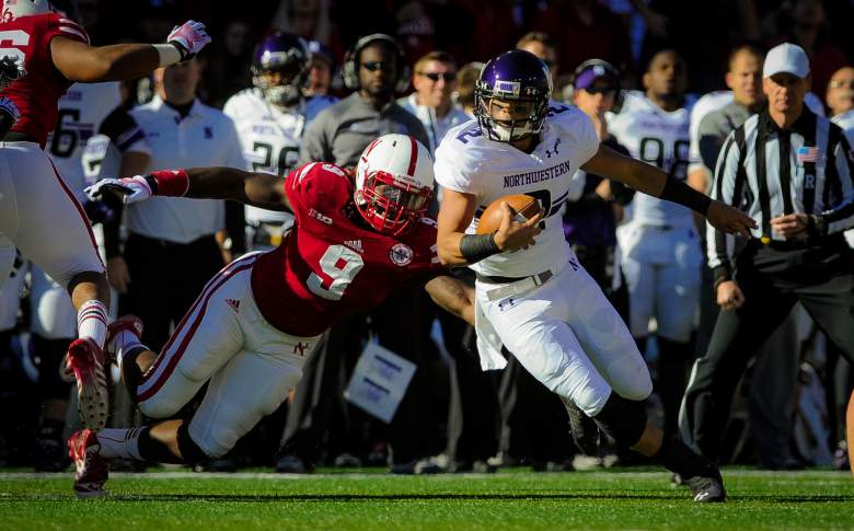 LINCOLN, NE - NOVEMBER 2: Quarterback Kain Colter #2 of the Northwestern Wildcats slips past defensive end Jason Ankrah #9 of the Nebraska Cornhuskers during their game at Memorial Stadium on November 2, 2013 in Lincoln, Nebraska. (Photo by Eric Francis/Getty Images)