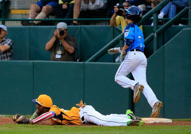 SOUTH WILLIAMSPORT, PA - AUGUST 23: Josiah Cromwick #7 of the West Team from Las Vegas, Nevada is forced out by first baseman Trey Hondras #24 of the Great Lakes Team from Chicago, Illinois for the final out of the game during the United States Championship game of the Little League World Series at Lamade Stadium on August 23, 2014 in South Williamsport, Pennsylvania. Great Lakes won 7-5. (Photo by Rob Carr/Getty Images)