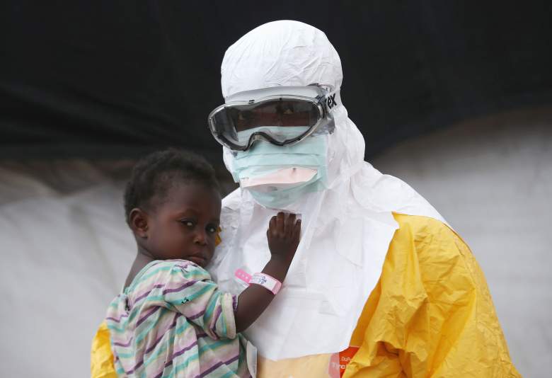 A Doctors Without Borders (MSF), health worker in protective clothing holds a child suspected of having Ebola in the MSF treatment center on October 5, 2014 in Paynesville, Liberia. The girl and her mother, showing symptoms of the deadly disease, were awaiting test results for the virus. The Ebola epidemic has killed more than 3,400 people in West Africa, according to the World Health Organization.  (Getty Images)