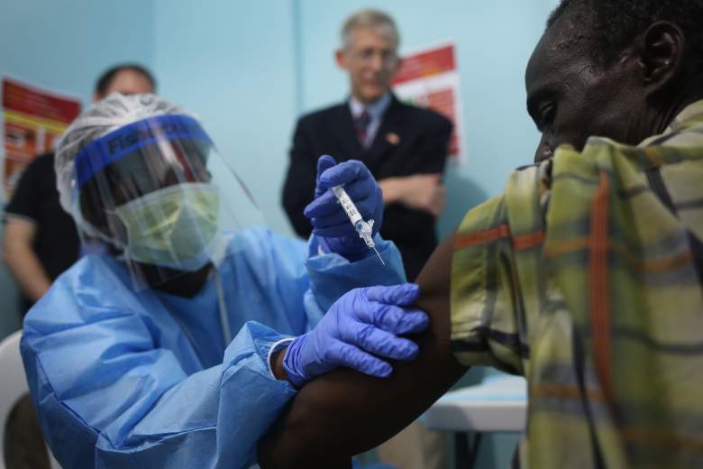 A nurse administers an injection on the first day of the Ebola vaccine study being conducted at Redemption Hospital, formerly an Ebola holding center, on February 2, 2015 in Monrovia, Liberia. Twelve people were given injections Monday, out of a planned 27,000 people in the Monrovia area. The clinical research study is being conducted jointly by the U.S. National  Institutes of Health (NIH), and the Liberian Ministry of Health. The Ebola epidemic virus has killed at least 3,700 people in Liberia alone, the most of any country, and nearly 9,000 across in West Africa. In background of photo is Dr. Clifford Lane, Clinical Director of the U.S. National Institute for Allergy and Infectious Diseases. (Getty Images)