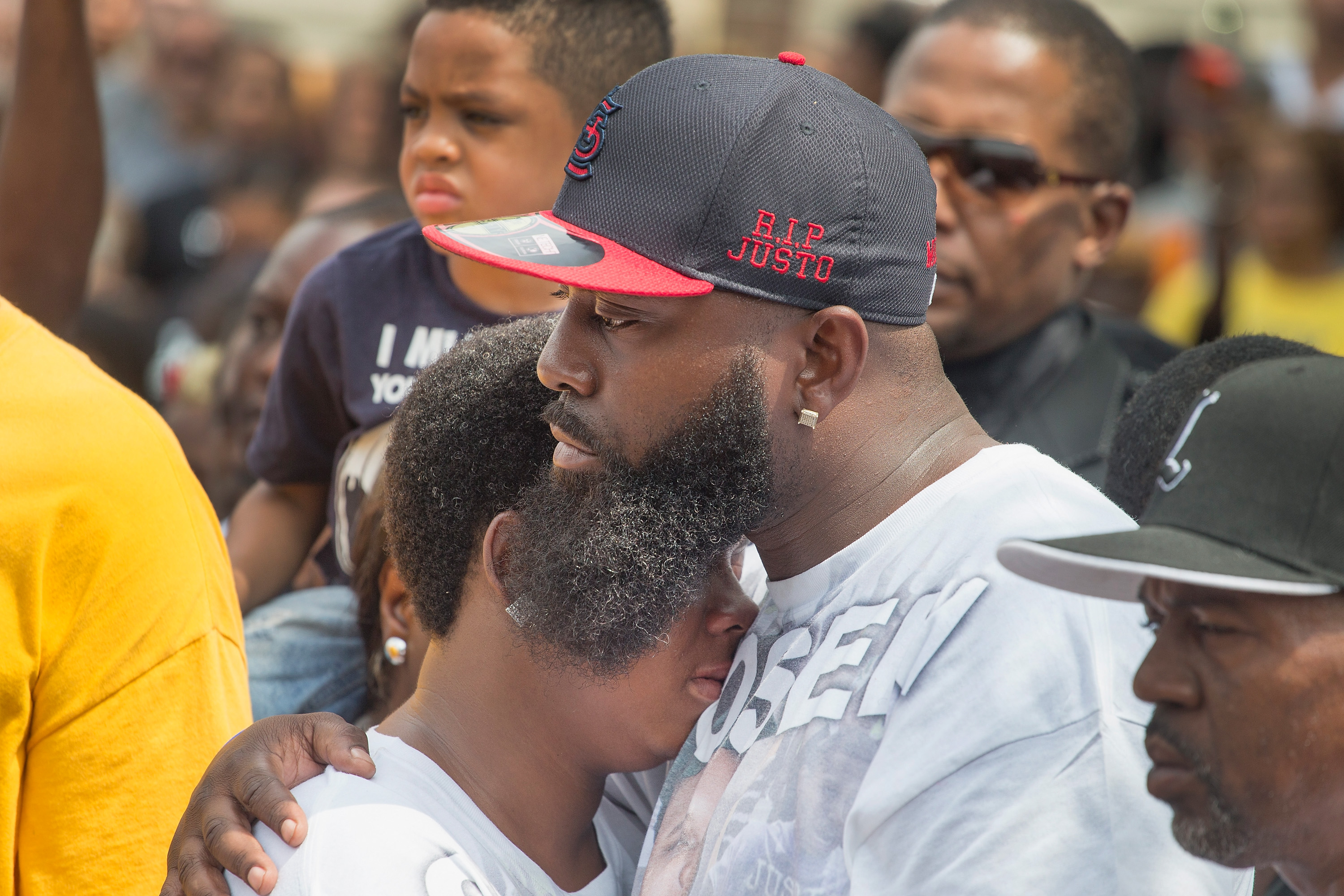 Michael Brown Sr. comforts his wife during a moment of silence for his son. (Getty)