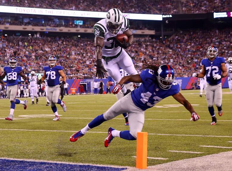 EAST RUTHERFORD, NJ - AUGUST 29: Zac Stacy #38 of the New York Jets jumps over Brandon Meriweather #43 of the New York Giants to score a touchdown in the second quarter during preseason action at MetLife Stadium on August 29, 2015 in East Rutherford, New Jersey. (Photo by Elsa/Getty Images)