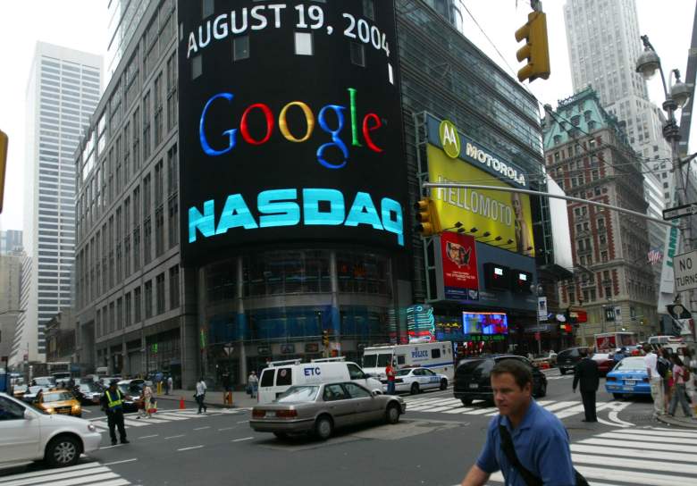 NEW YORK - AUGUST 19:  A pedestrian passes a sign marking Google being traded on the NASDAQ Marketsite August 19, 2004 in New York City. Shares of Google Inc. were expected to begin trading publicly on the Nasdaq Stock Market August 19, at a lower per share price than anticipated.  (Photo by Chris Hondros/Getty Images)