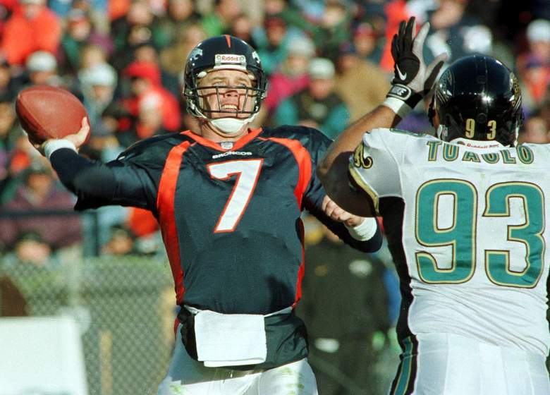 Tuaolo (R) tries to chase down John Elway during a game in 1997.