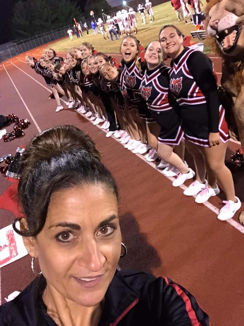 Berrious pictured with her former charges prior to a Lackawanna football game. (Facebook)