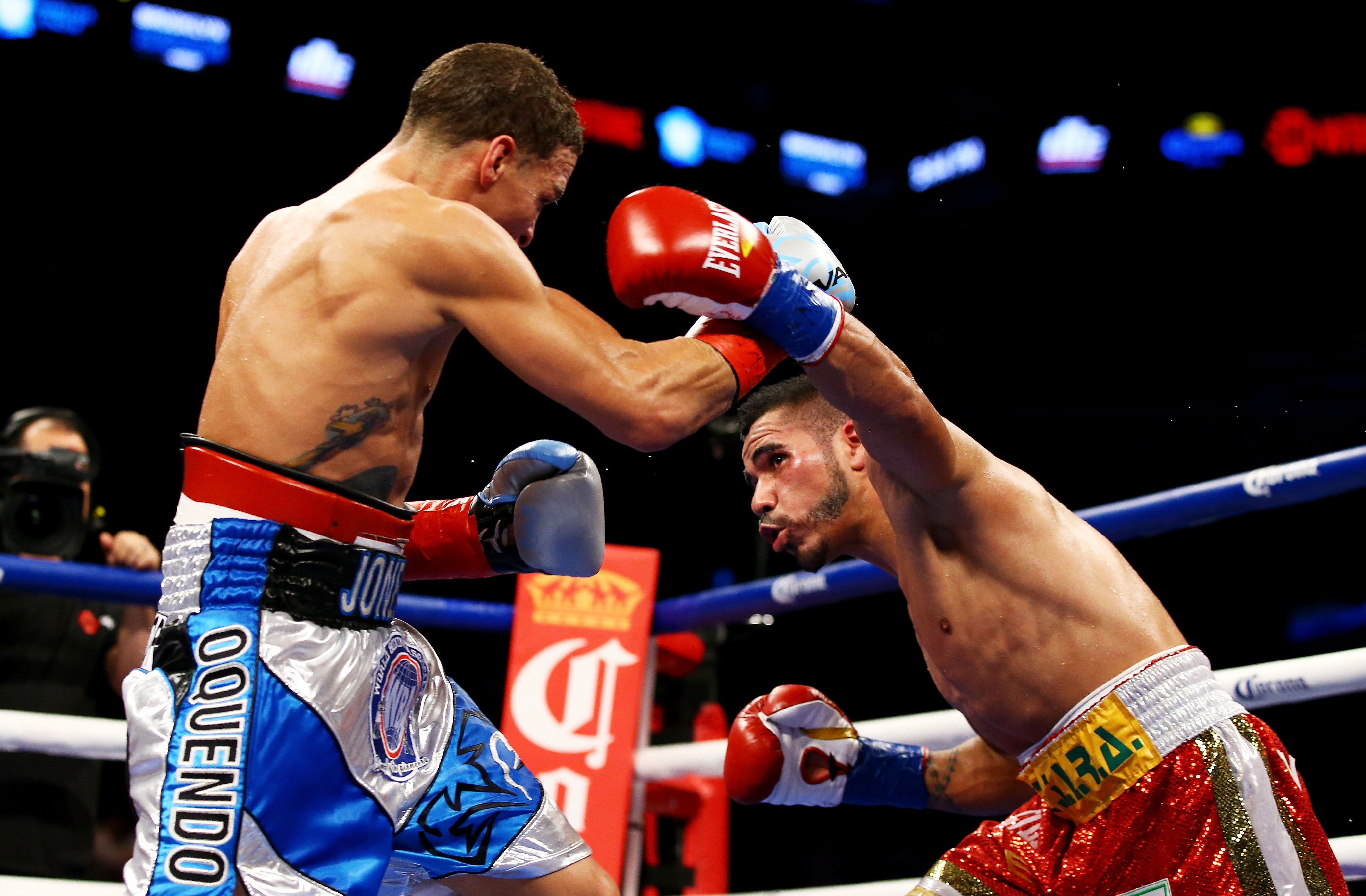  Jesus Cuellar (R) of Argentina punches Jonathan Oquendo of Puerto Rico during their WBA Featherweight Championship bout. (Getty)
