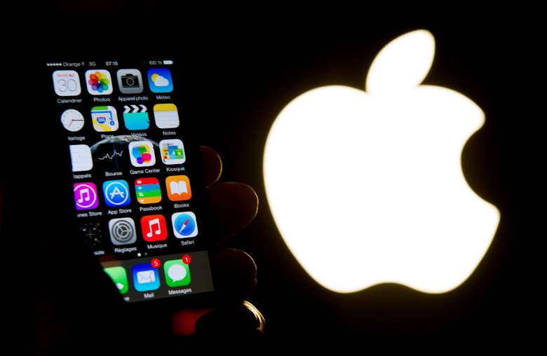An illustration of an iPhone held up in front of the Apple Inc. logo taken of January 30, 2015 in Lille. AFP PHOTO / PHILIPPE HUGUEN (Photo credit should read PHILIPPE HUGUEN/AFP/Getty Images)