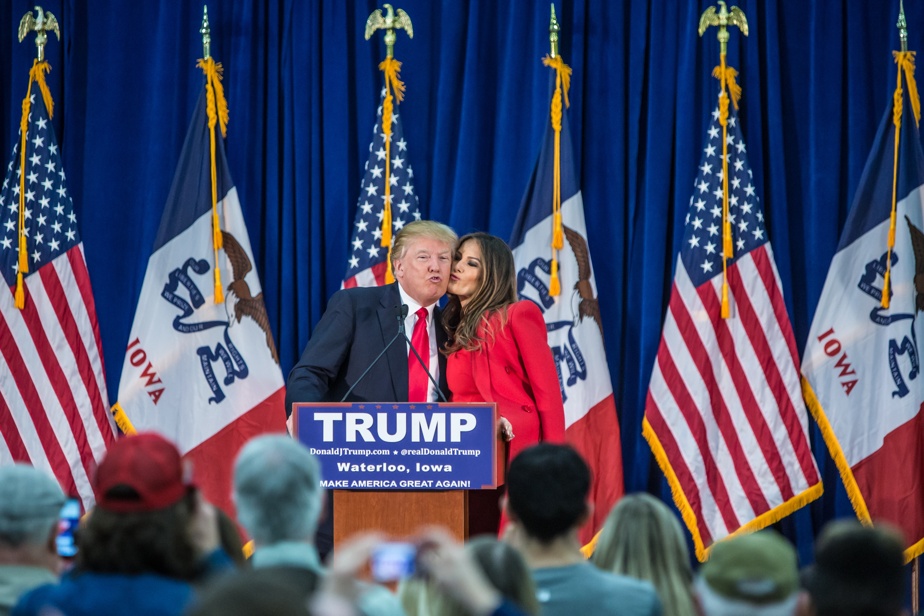 Republican presidential candidate Donald Trump, left, is greeted by his wife Melania Trump at a campaign rally at the Ramada Waterloo Hotel and Convention Center on February 1, 2016 in Waterloo, Iowa. (Getty)