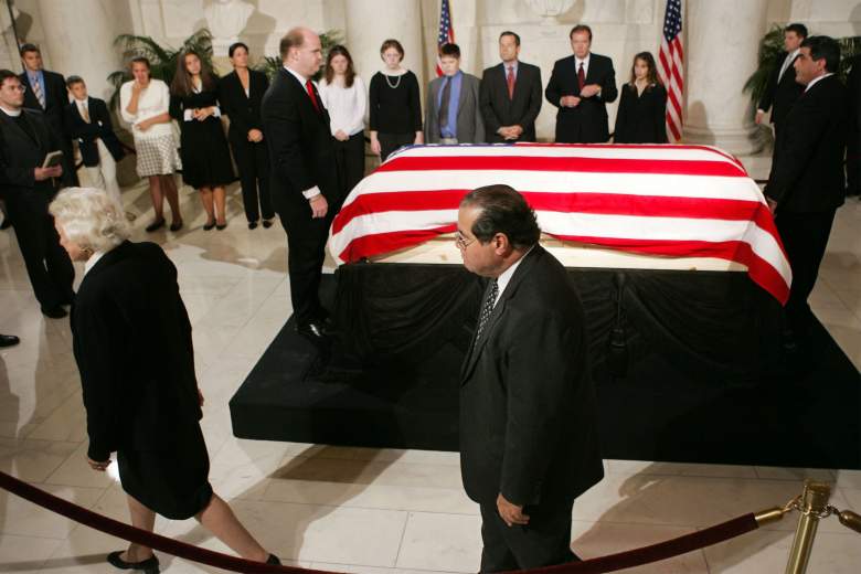 WASHINGTON - SEPTEMBER 06: The casket of Chief Justice William H. Rehnquist lies in the Great Hall of the U.S. Supreme Court as Associate Justice Antonin Scalia (C) and Sandra Day O'Connor (L) walk past September 6, 2005 in Washington, DC. The casket with the remains of Rehnquist, the nation's 16th chief justice, will lie in repose at the U.S. Supreme Court where he sat for more than thirty years. (Photo by Charles Dharapak-Pool/Getty Images)