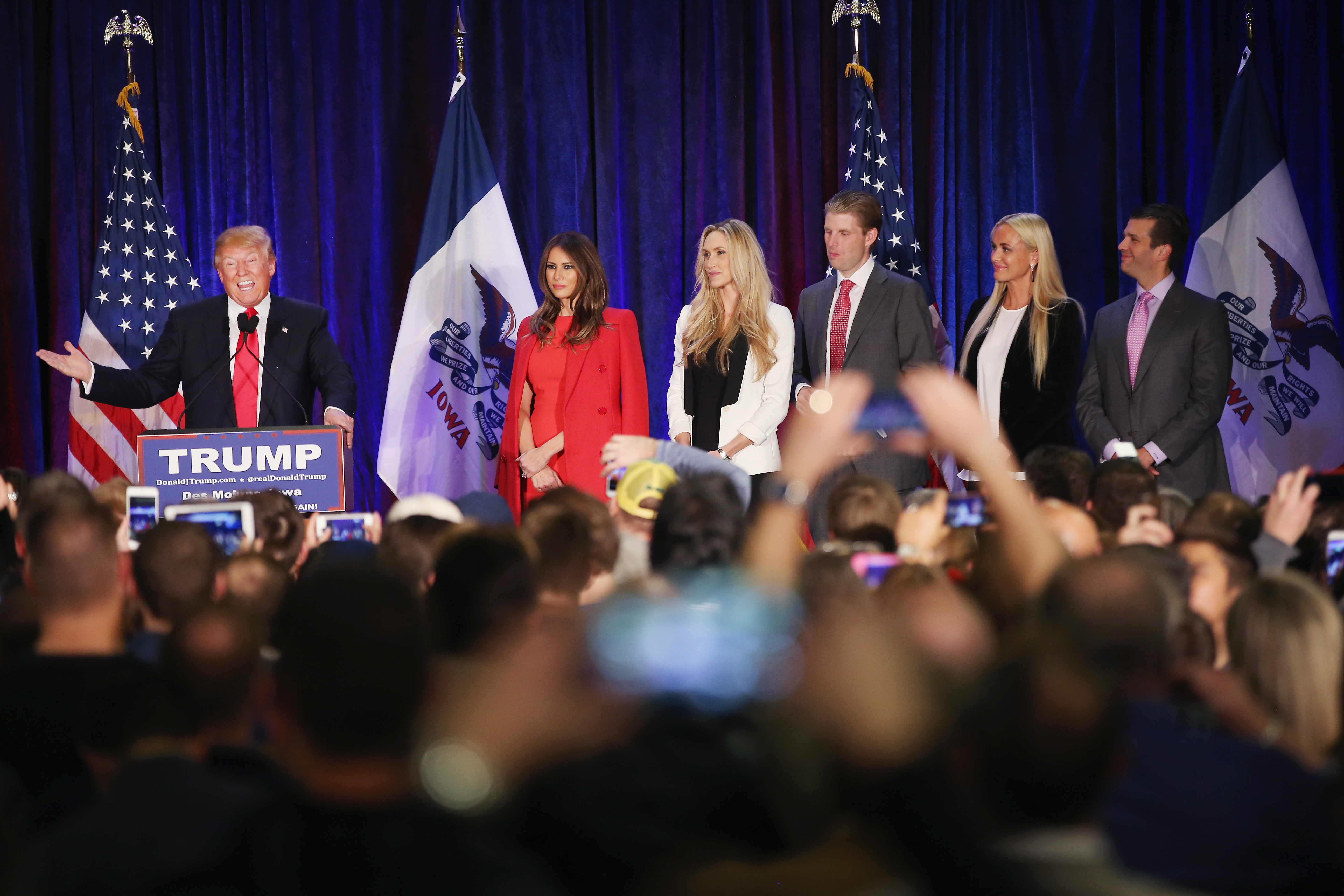 Republican presidential candidate Donald Trump speaks at his Iowa Caucus night gathering while his wife Melania (2nd R-L), daughter-in-law Lara Yunaska, son Eric, daughter-in-law Vanessa Haydon, and son Donald Trump Jr. look on  February 1, 2016 in Des Moines, Iowa.   (Getty)