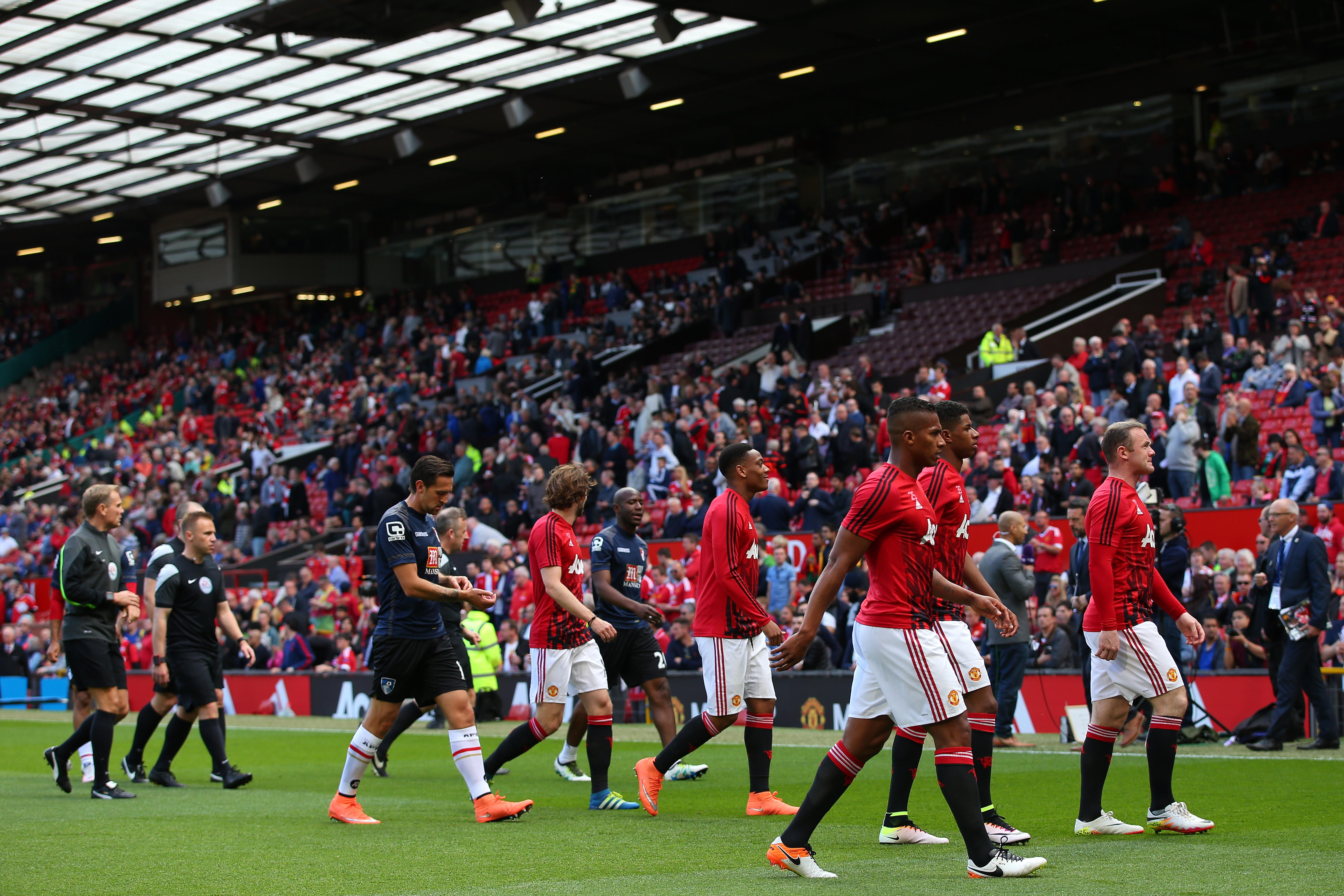 Players leave the field before the match was abandoned prior to the Barclays Premier League match between Manchester United and AFC Bournemouth at Old Trafford on May 15, 2016 in Manchester, England. (Getty)