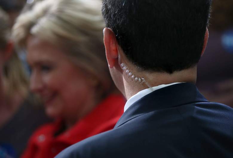 A secret service agent protects Hillary Clinton during a campaign stop in Iowa. (Getty)