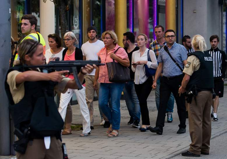 MUNICH, GERMANY - JULY 22: Police officers escort people from inside the shopping center as they respond to a shooting at the Olympia Einkaufzentrum (OEZ) at July 22, 2016 in Munich, Germany. According to reports, several people have been killed and an unknown number injured in a shooting at a shopping centre in the north-western Moosach district in Munich. Police are hunting the attacker or attackers who are thought to be still at large. (Photo by Joerg Koch/Getty Images)
