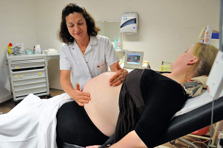 A pregnant woman is examined at a doctor's office. (Getty)